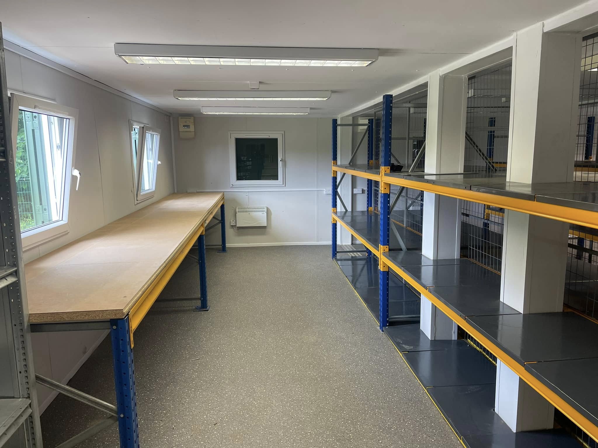Shelving and workbench installation in a fitted workspace